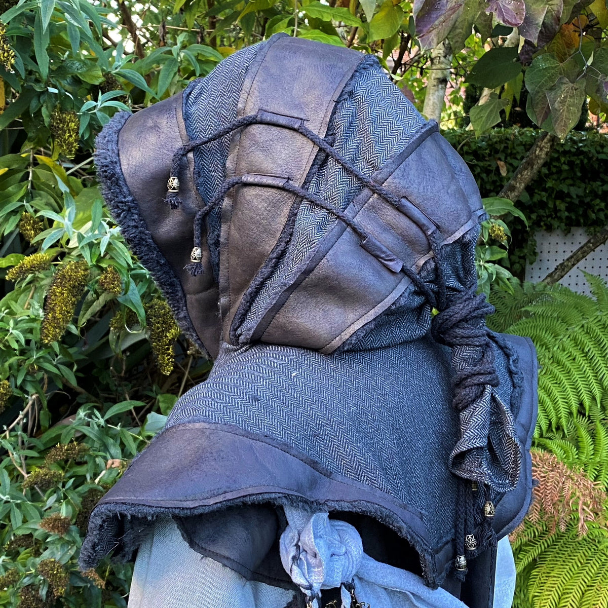 Dark hunter LARP hood in dark fabric with textured details, side view.