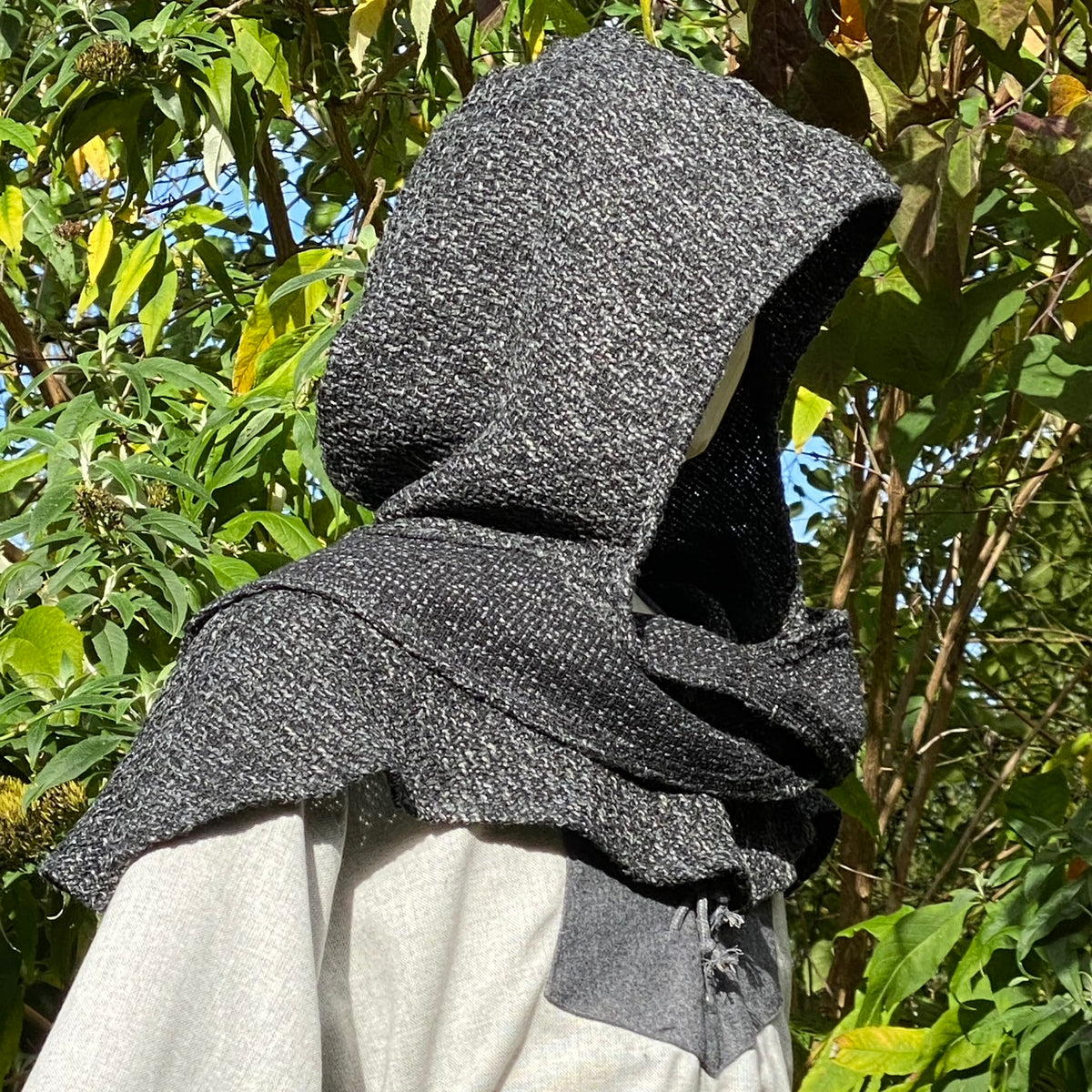 Grey textured hooded cloak detail in sunlight, medieval LARP style.