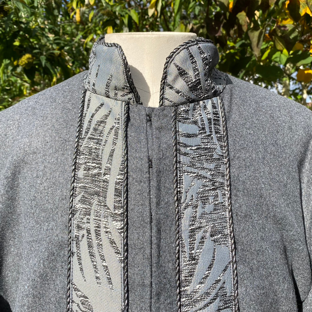Medieval LARP grey coat with detailed embroidered collar close-up.