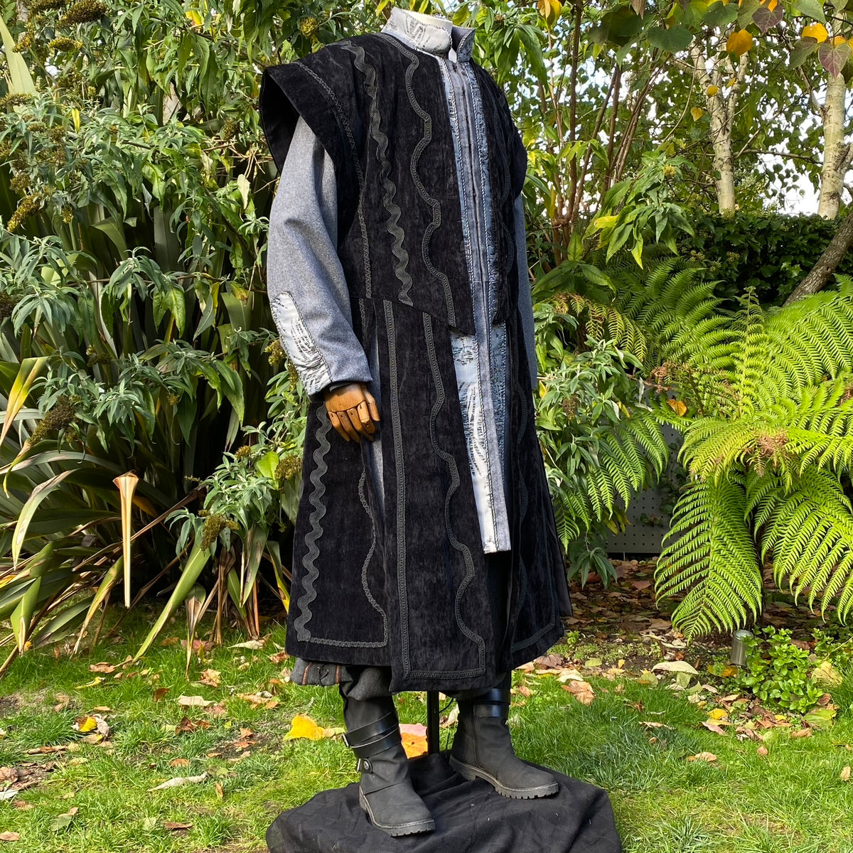 Side angle of wizard-style waistcoat with wide shoulders and ornate silver braiding for LARP.