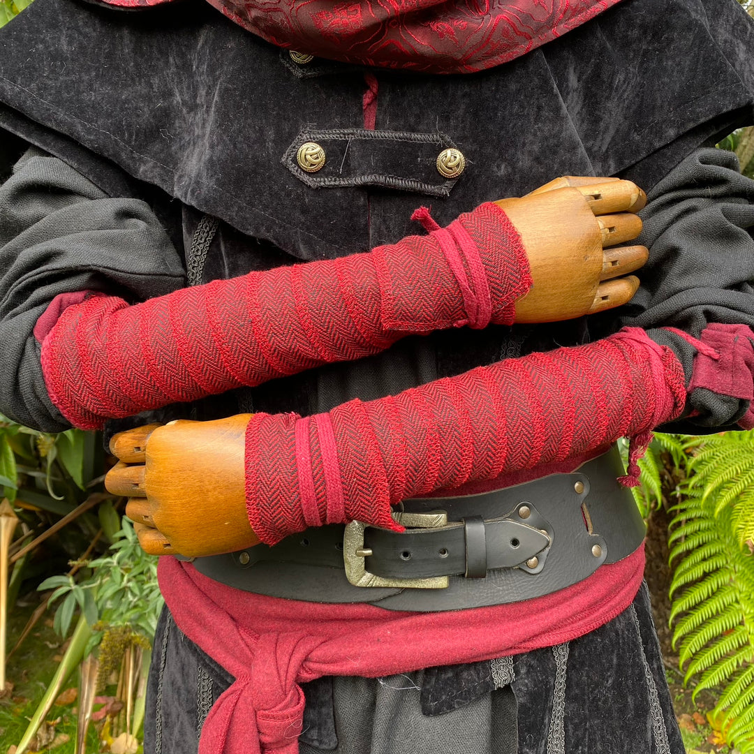 Red herringbone wool arm wraps for medieval or LARP attire, close view.