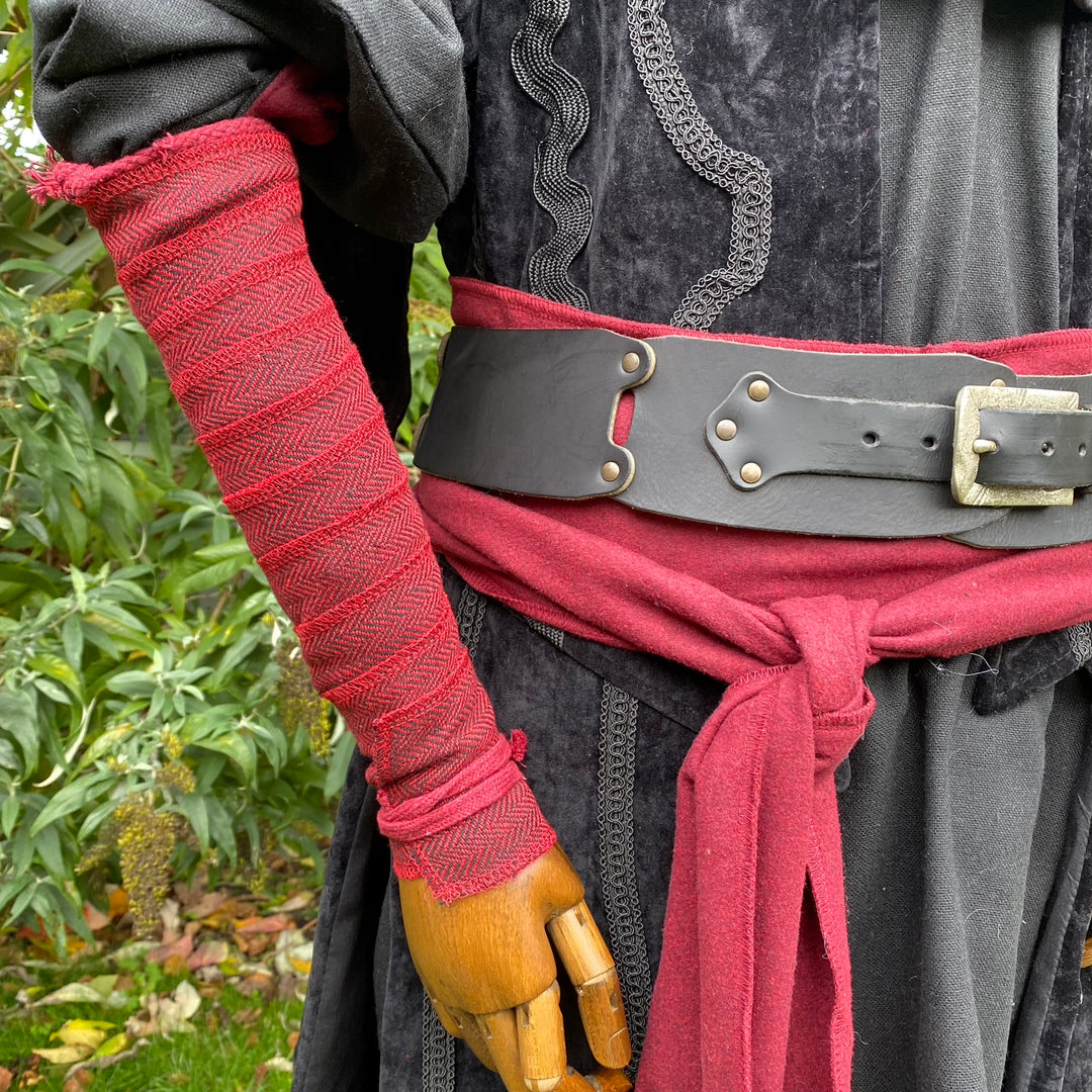 Red herringbone arm wrap, medieval belt with black tunic for LARP.