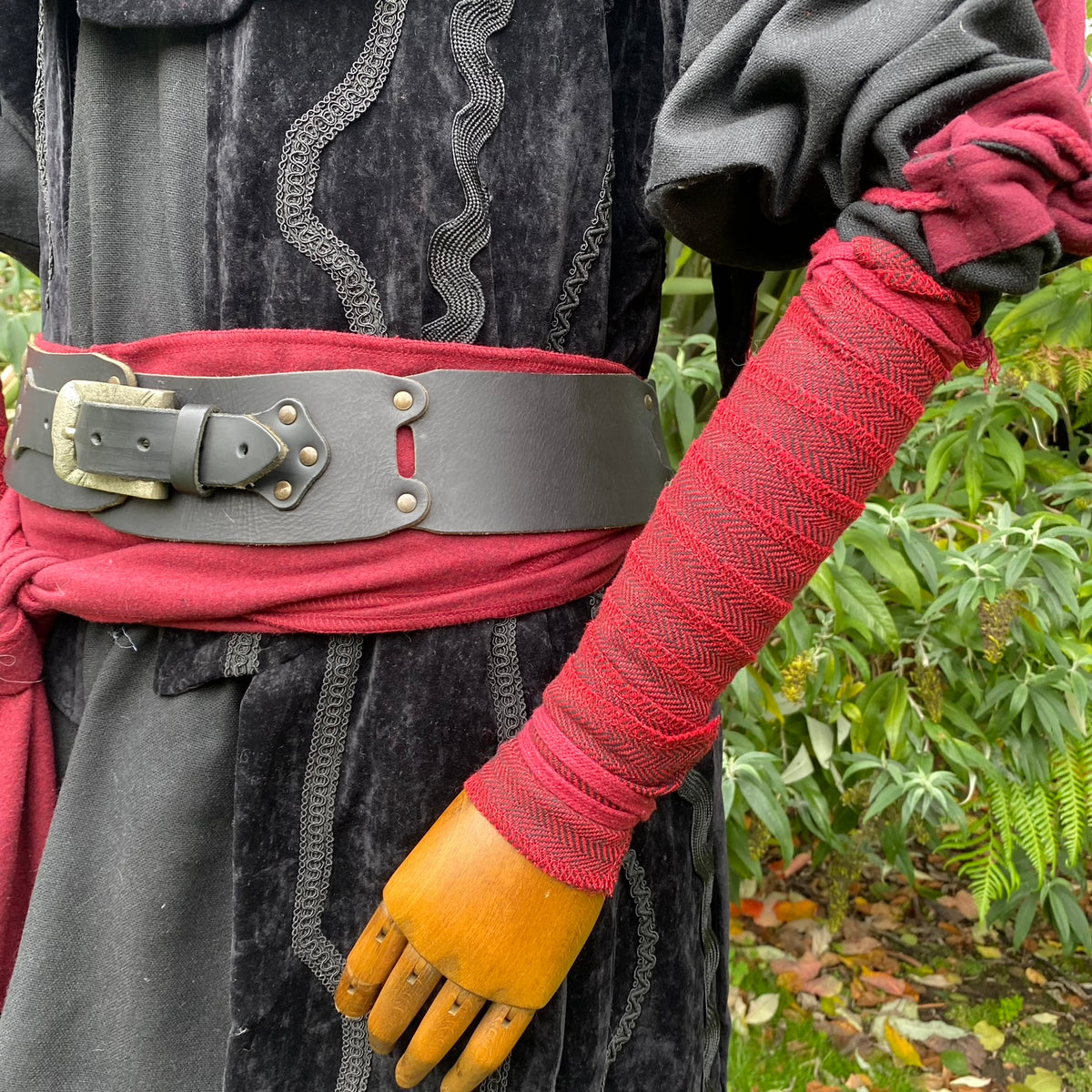 Red herringbone wool arm wrap, medieval style for LARP, side view.
