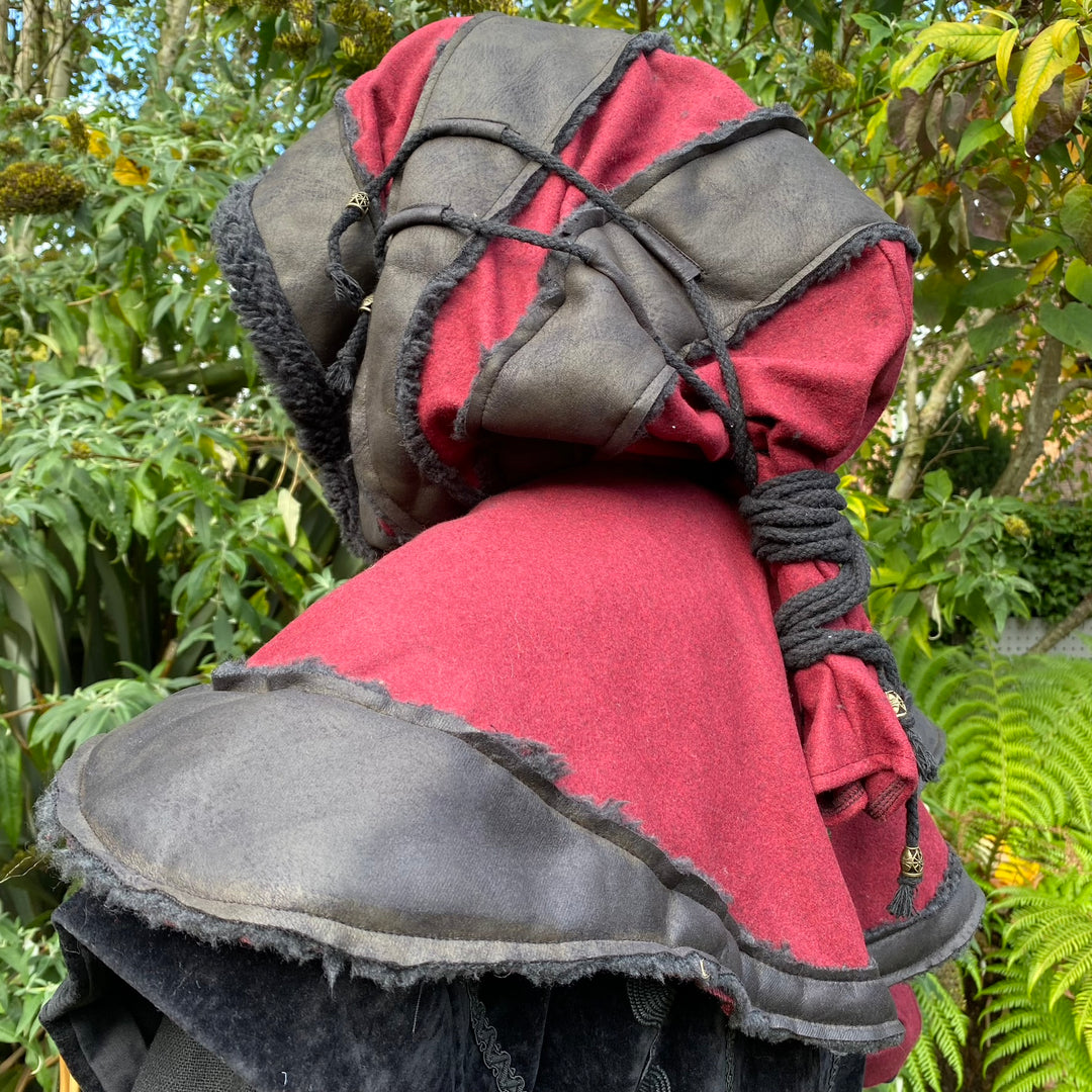 Red and black LARP hood with layered fabrics and rope, side view.
