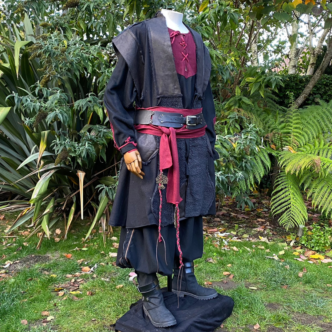 LARP waistcoat with red accents, black boots.
