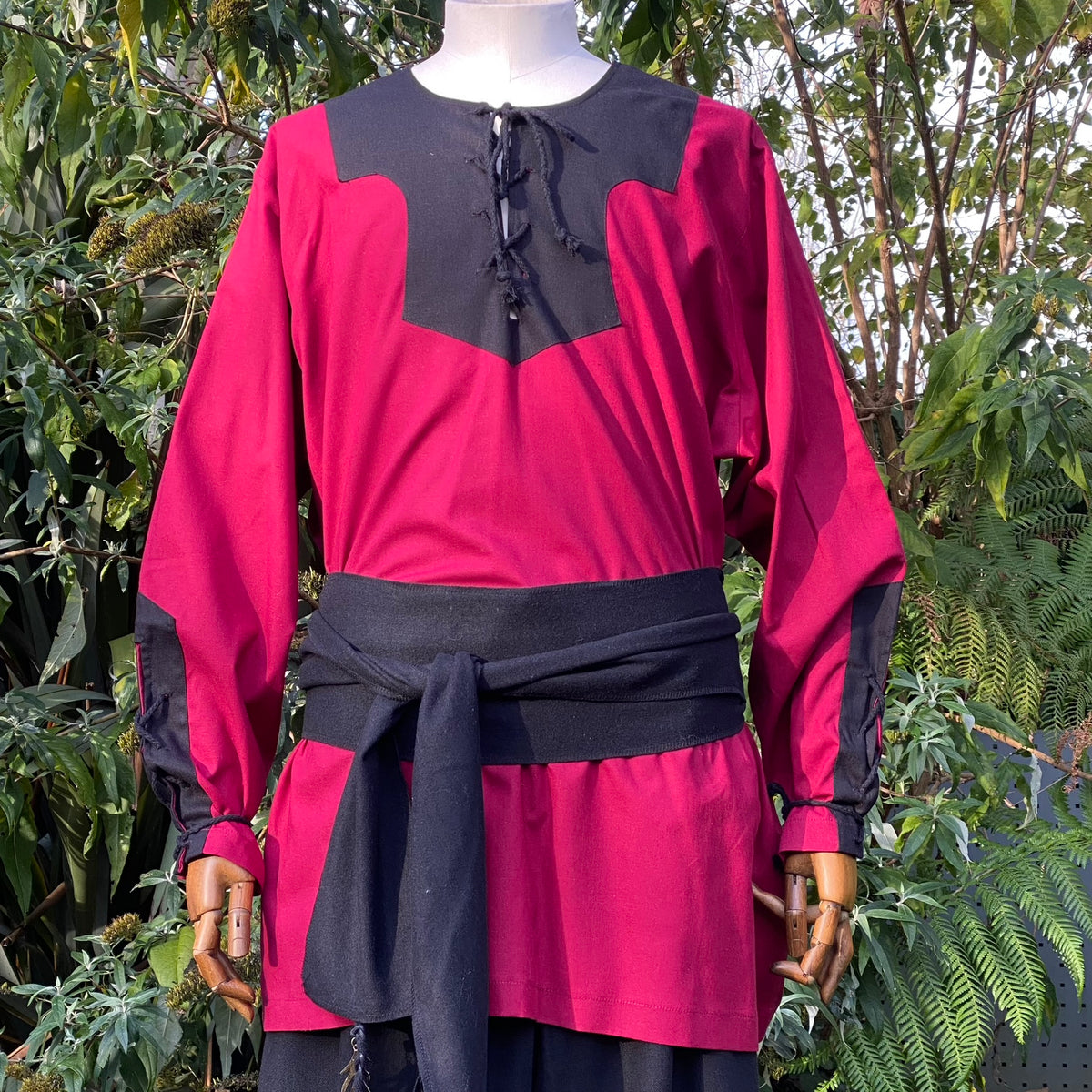 Mid-front view of red and black tunic from LARP Viking costume.