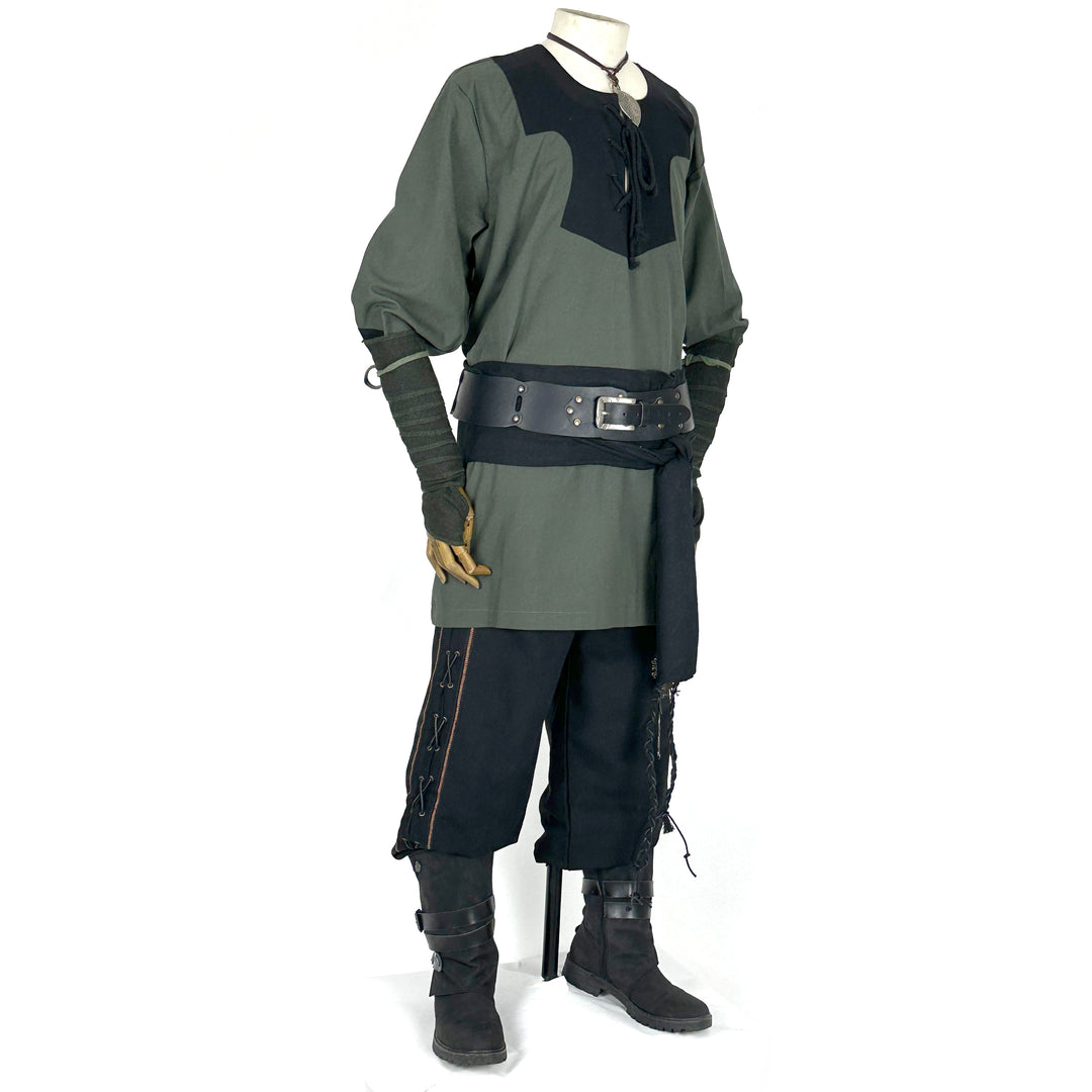 Medieval LARP outfit side view, featuring a green and black viking tunic, arm wraps, trousers.