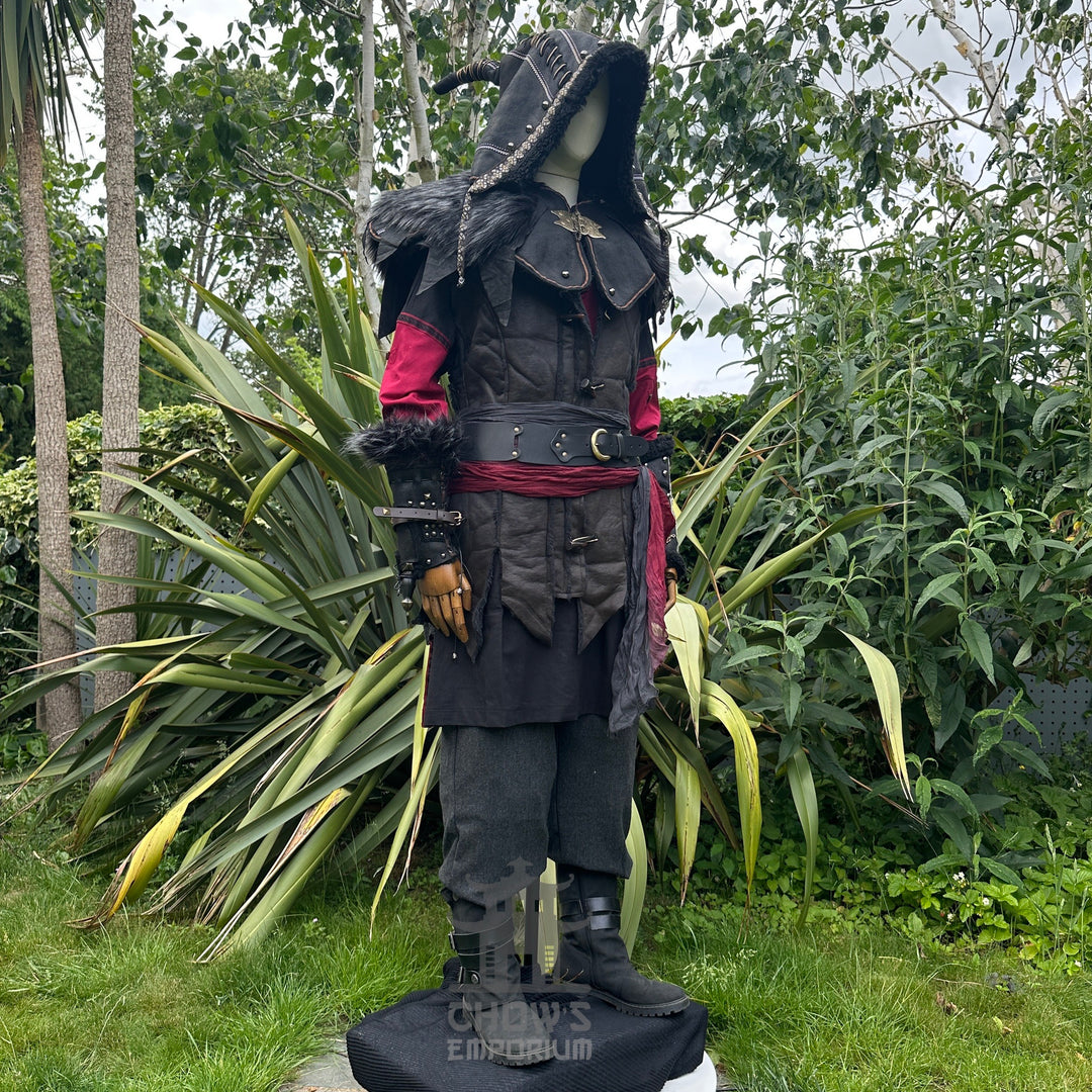 Medieval LARP outfit side view, featuring an ornate hood, waistcoat, tunic, trousers, vambraces.