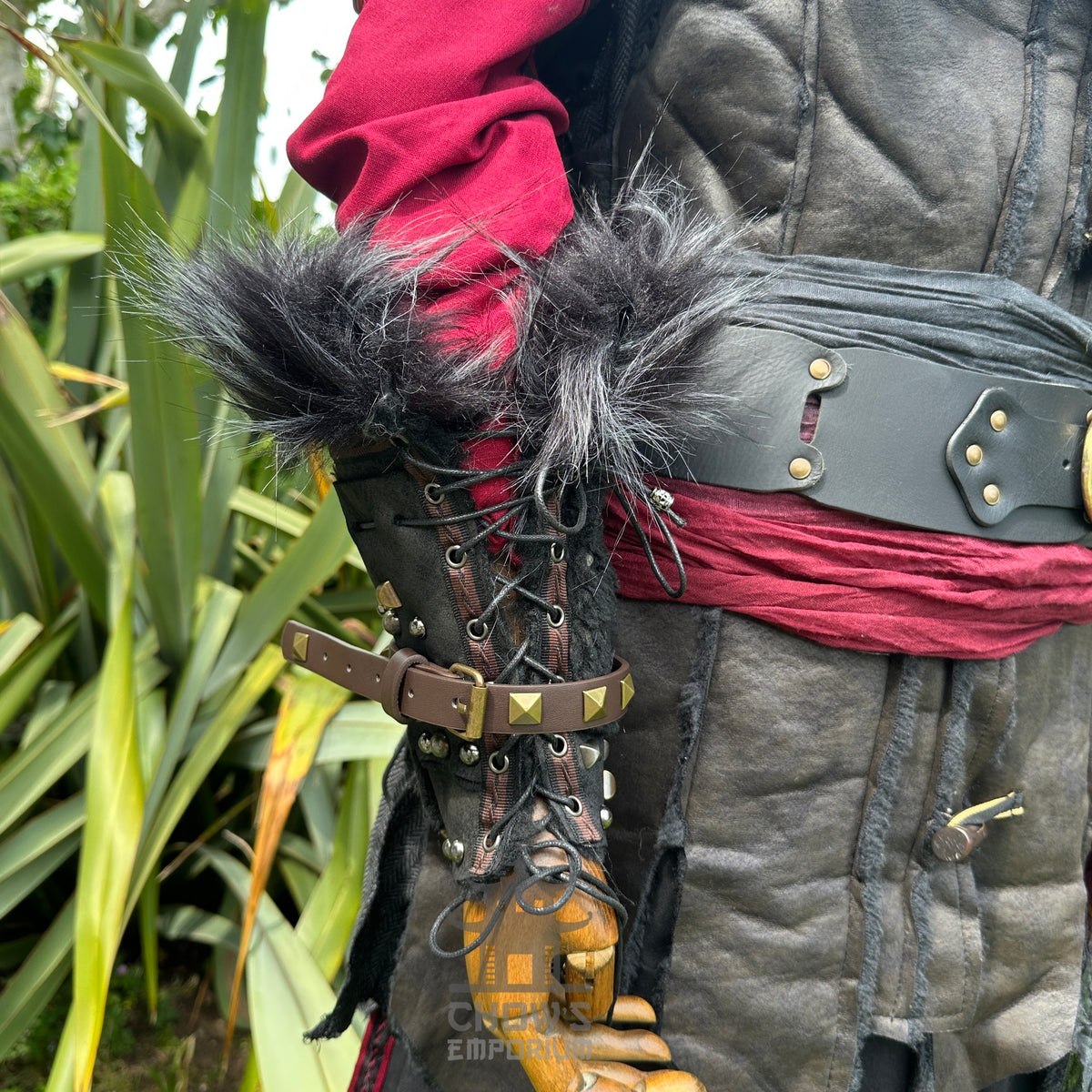 Crimson and black LARP outfit with fur vambraces, leather belt, and sash.