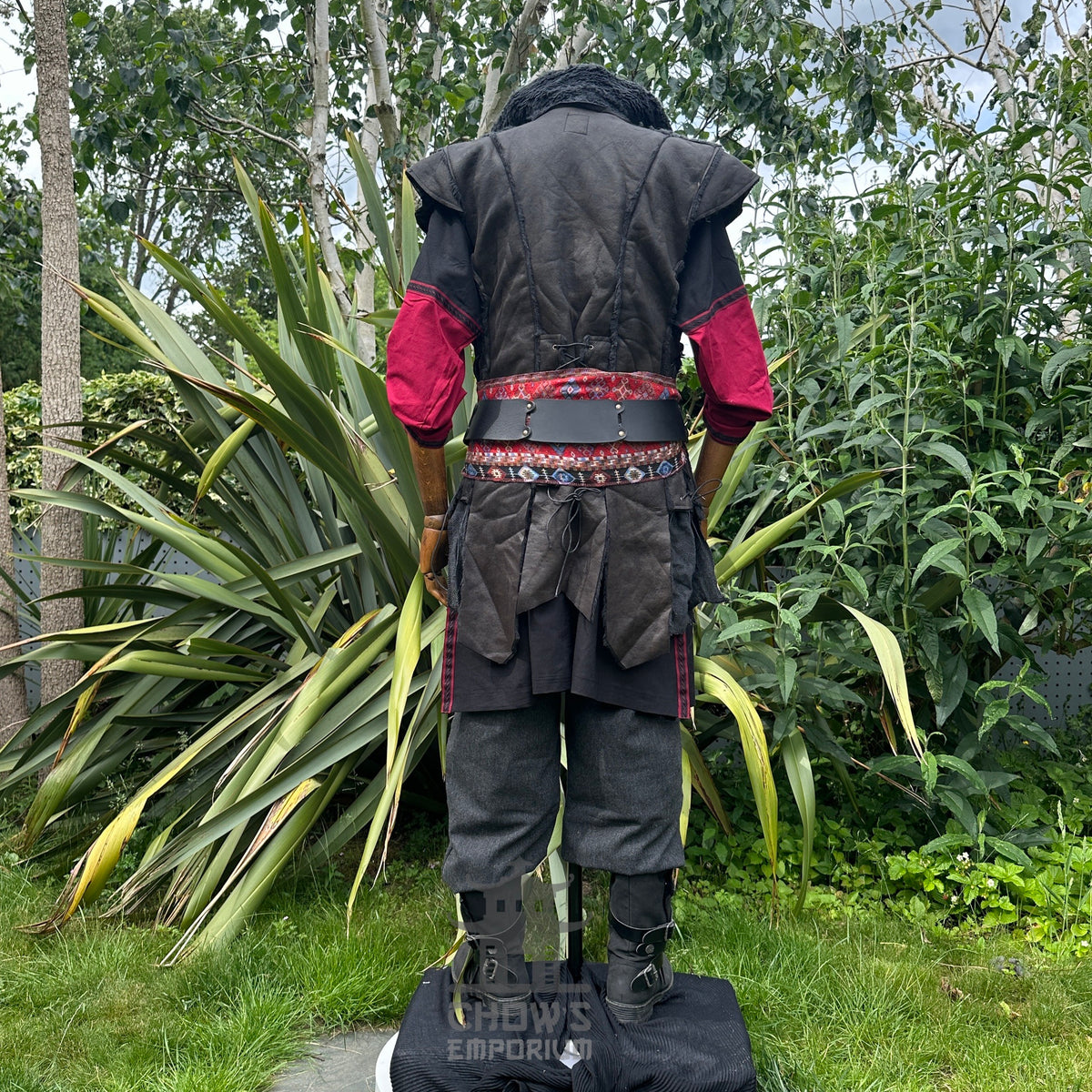 Back view of LARP outfit with red sash and layered waistcoat.