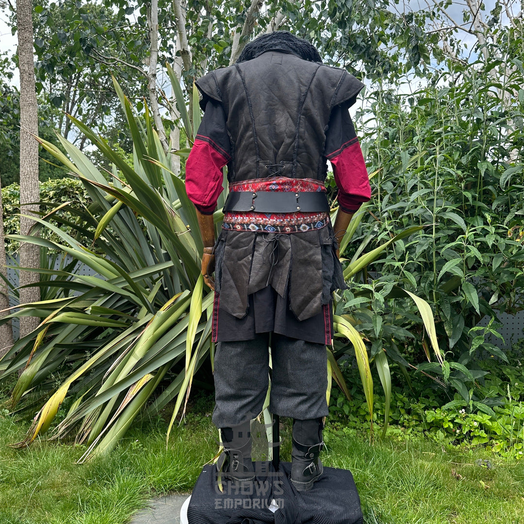 Back view of LARP outfit with red sash and layered waistcoat.
