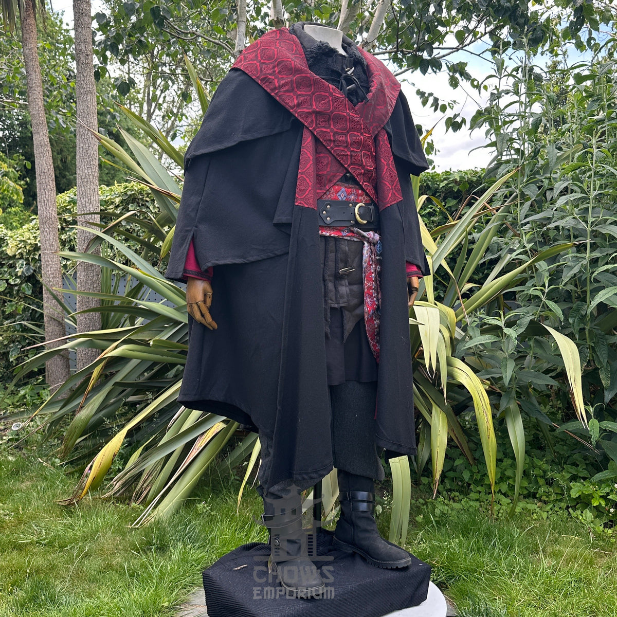 Mannequin side view of layered LARP cloak with ornate red patterns, medieval style.