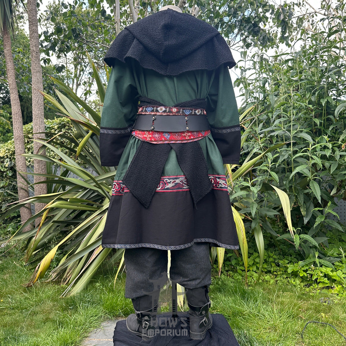 Medieval LARP outfit back view, featuring a green and black Viking tunic, hood, trousers and sash.