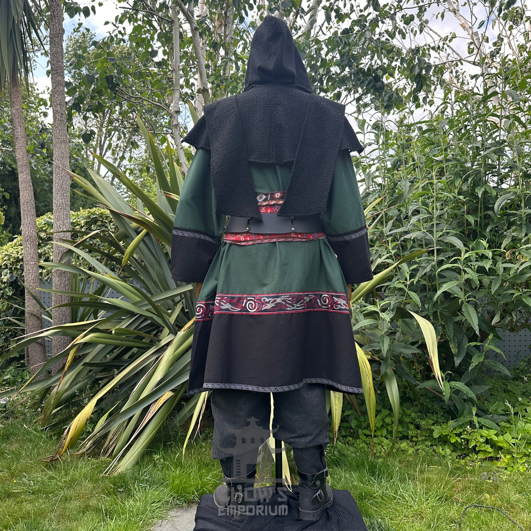 LARP medieval outfit: green tunic, black hood, trousers, sash, rear view.