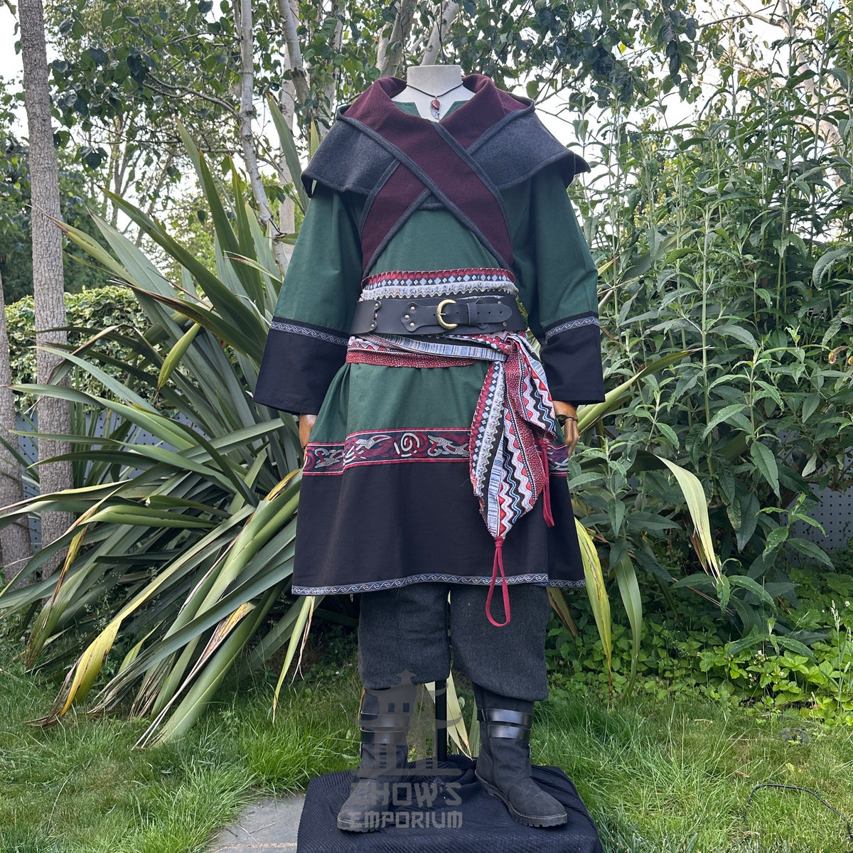 Green and black LARP outfit with tunic, trousers, and sash setup.
