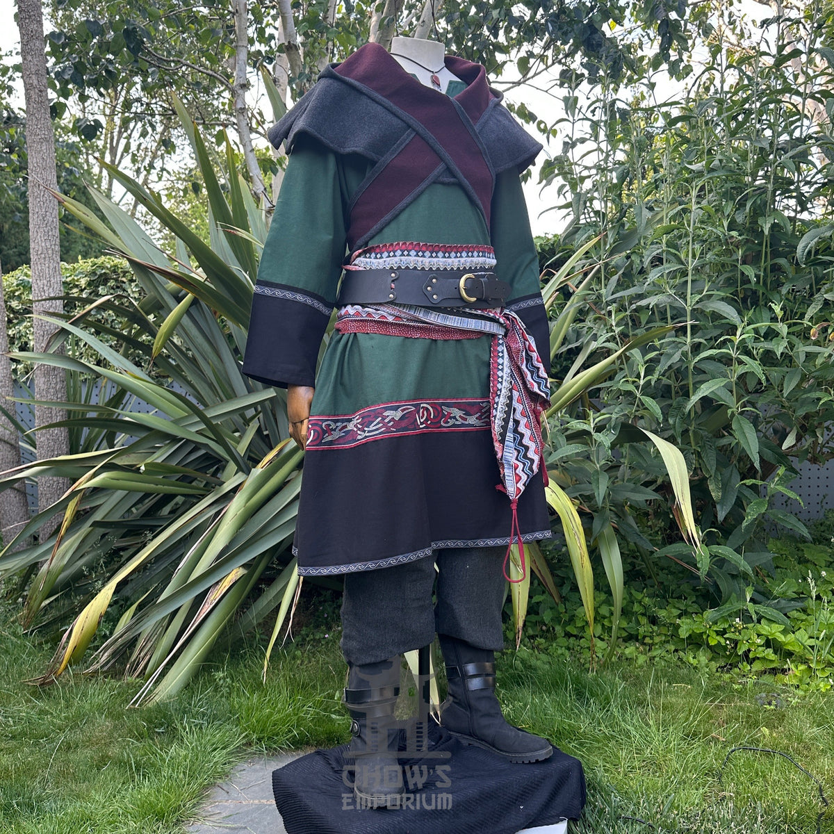 Medieval LARP outfit with green tunic, red trim, and detailed belt.