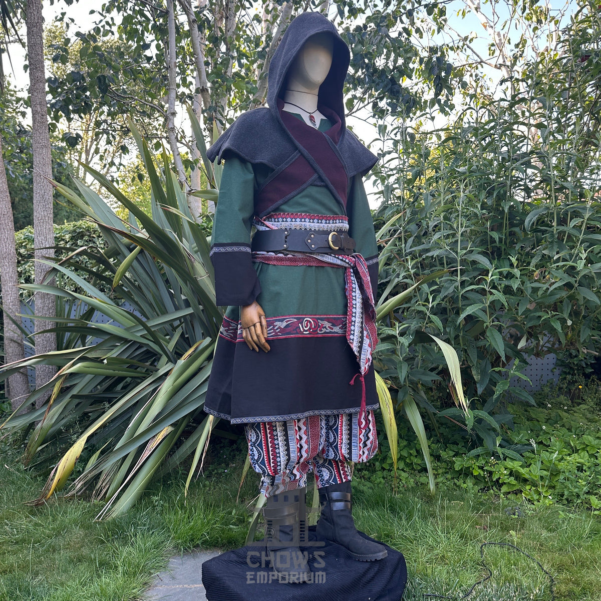 Medieval LARP outfit side view, featuring a green and black Viking tunic, reversible hood.