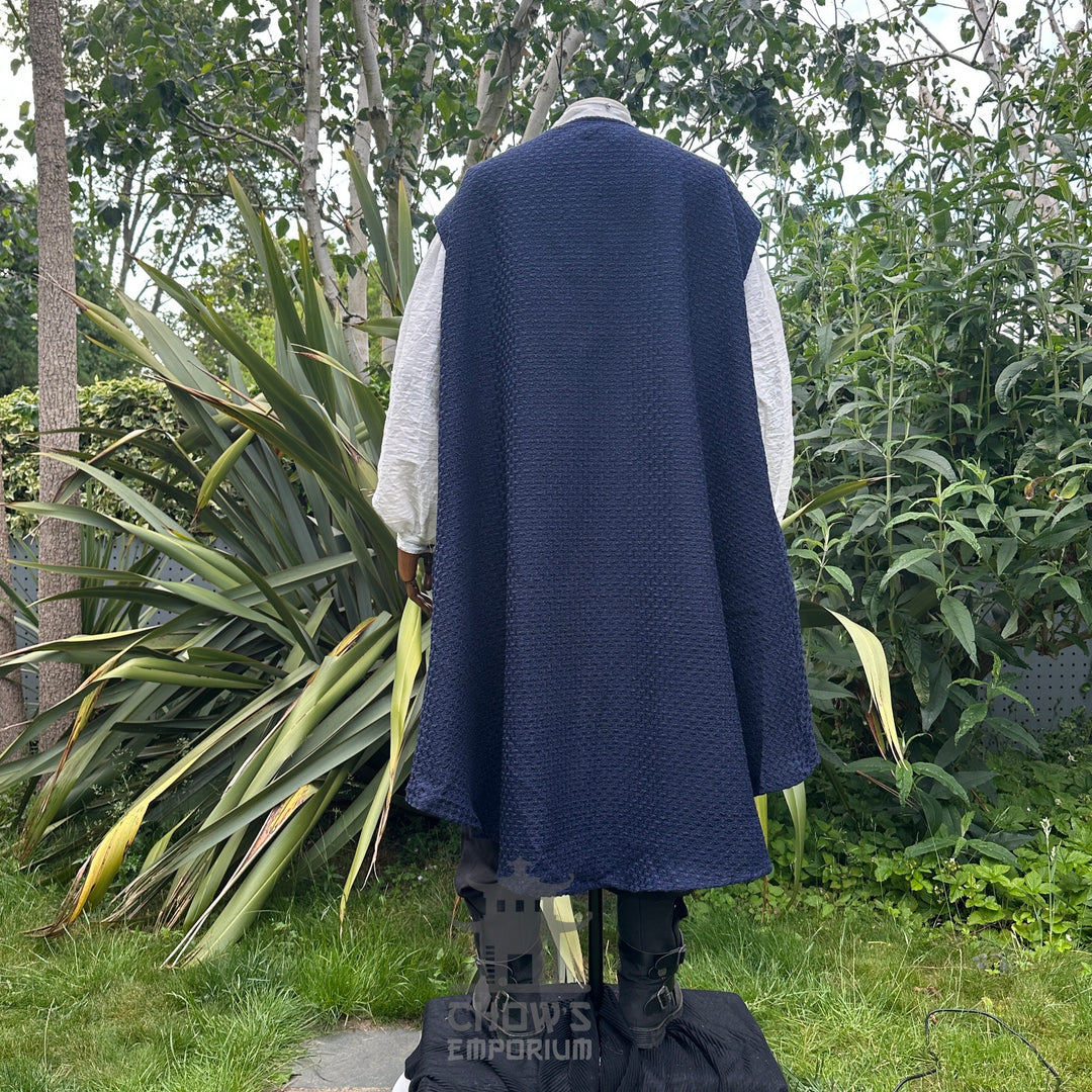 Back view of pirate waistcoat with loose flowing panels and blue sash.