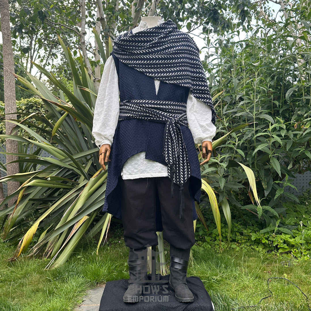 Medieval LARP pirate costume on mannequin, garden backdrop, draped sash.