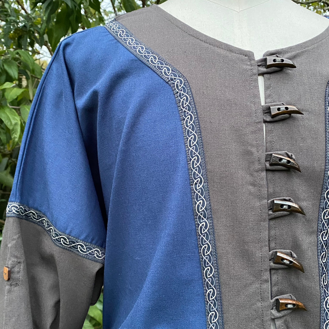 Blue and grey tunic with Celtic trim and clasps for LARP or medieval wear.