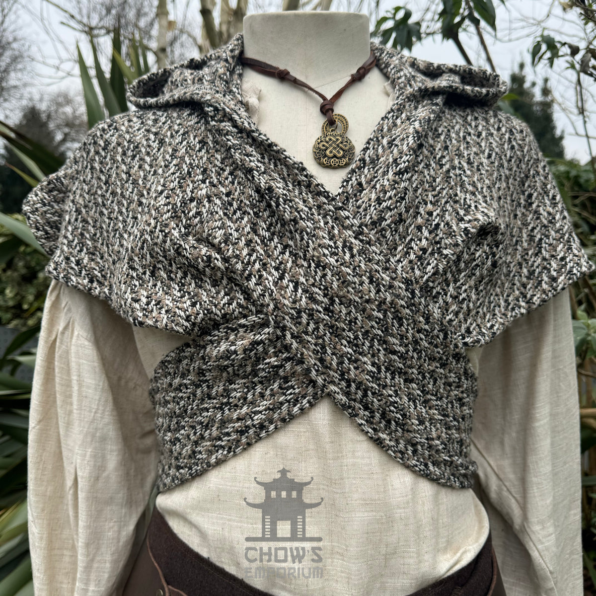 Brown, beige, and black medieval wool scarf hood on mannequin torso.