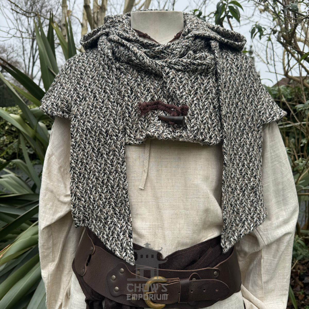 Mannequin with a speckled wool hood and a medieval belt for LARP attire.