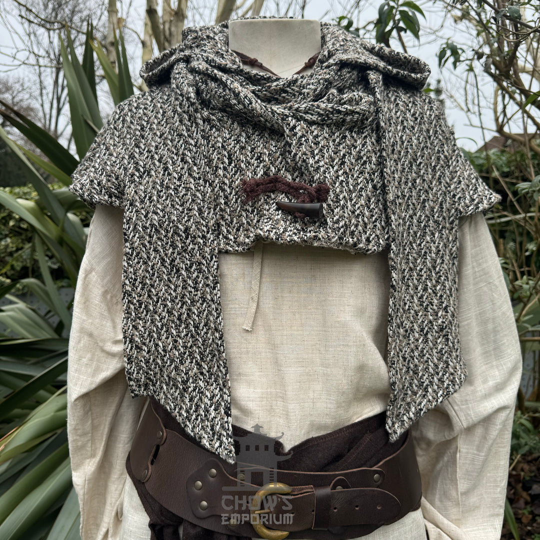 Mannequin with a speckled wool hood and a medieval belt for LARP attire.