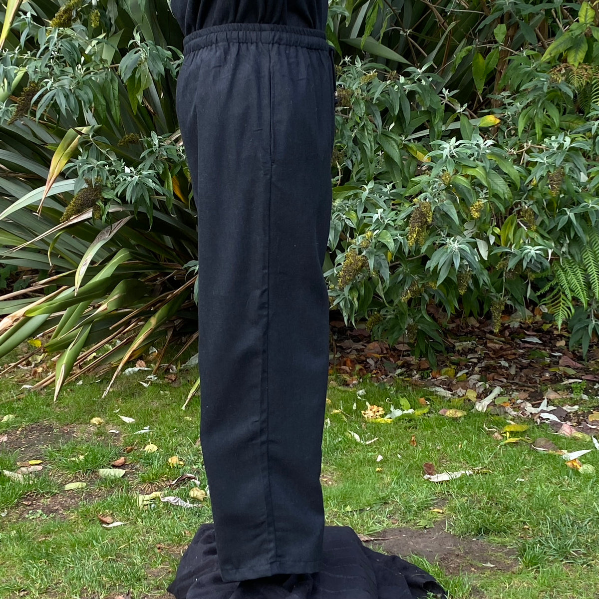Side view of medieval LARP straight leg pants in natural setting.