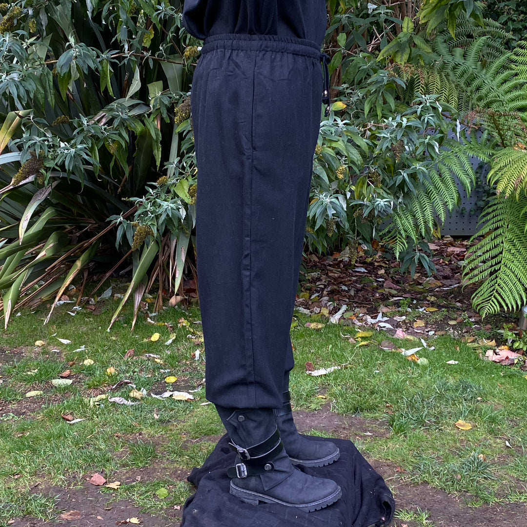 straight-leg medieval trousers in black wool fabric.