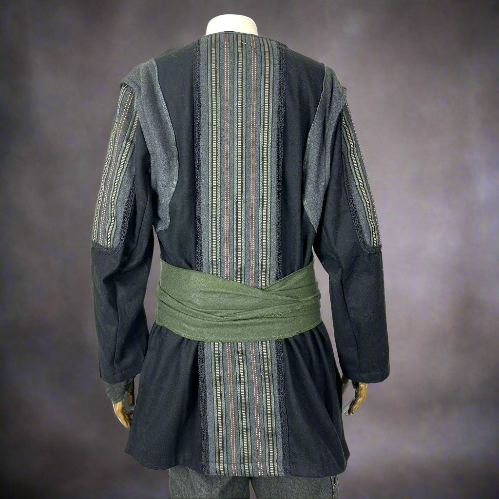 Back view of a medieval LARP set with green-striped black jacket and sash.