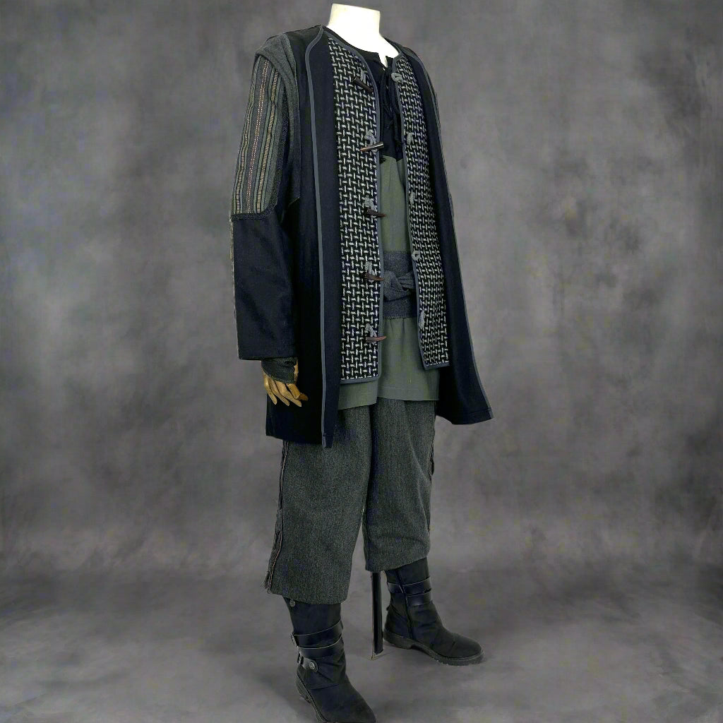 Dark LARP costume with decorated jacket, hood, and trousers, side view.