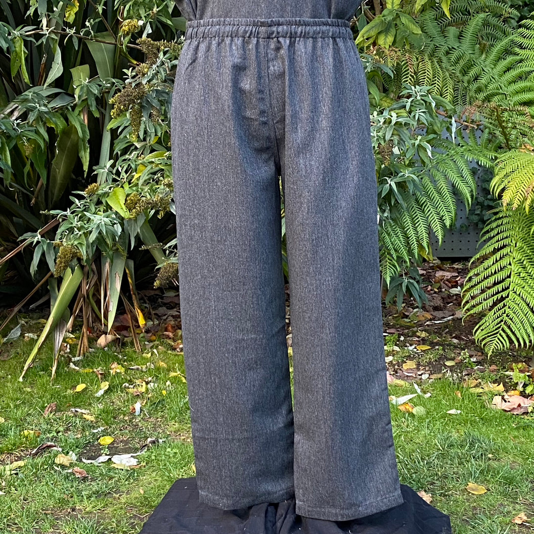 Back view of grey wool LARP trousers showing relaxed fit and reinforced seams no boots.