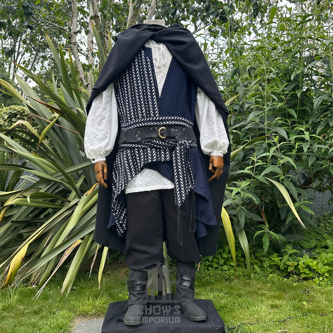A pirate costume with a black cloak, white shirt, and black pants in an outdoor setting.