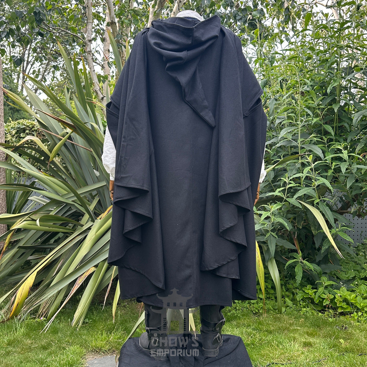 Medieval LARP costume back view featuring black cloak, waistcoat, shirt, pants, sash and necklace.