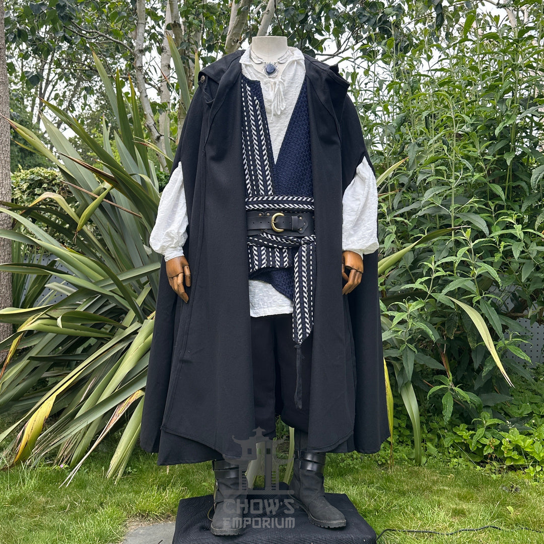 Medieval LARP outfit with cloak and sash, garden backdrop, front view.