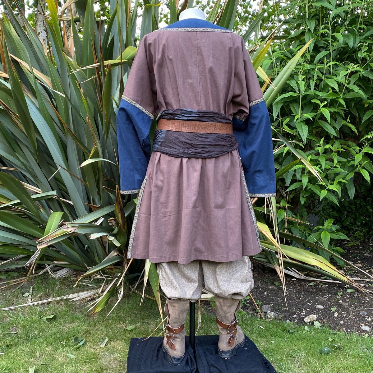 Rear view of brown tunic and blue sleeves in woodland setting for LARP.