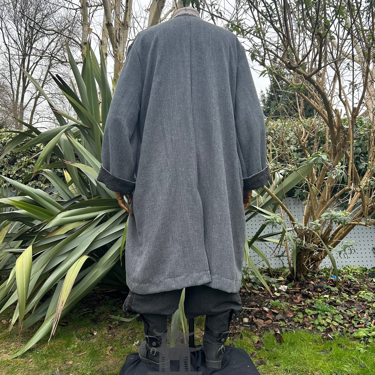 Medieval LARP outfit back view, featuring a grey two-tone jacket, shirt, trousers, belt and sash.