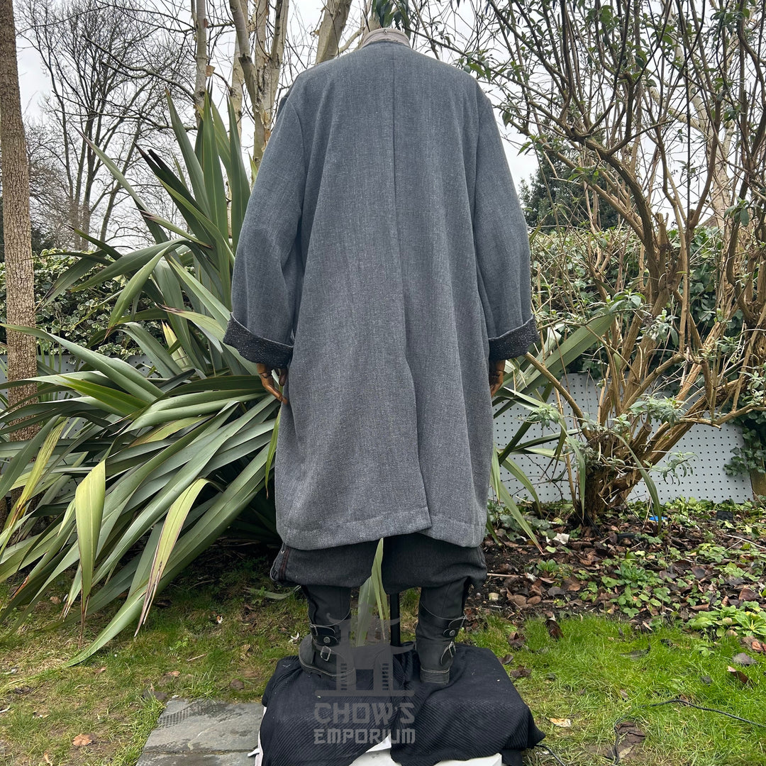 Back view of grey medieval LARP coat outdoors, showcasing wide sleeves.