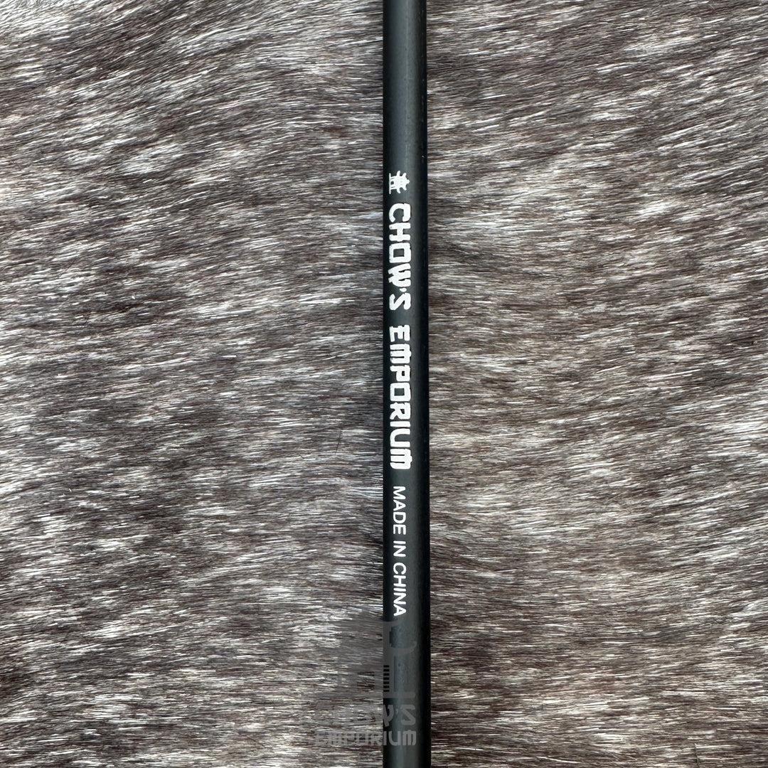 Black LARP arrow shaft with flat foam head, side view on textured background.