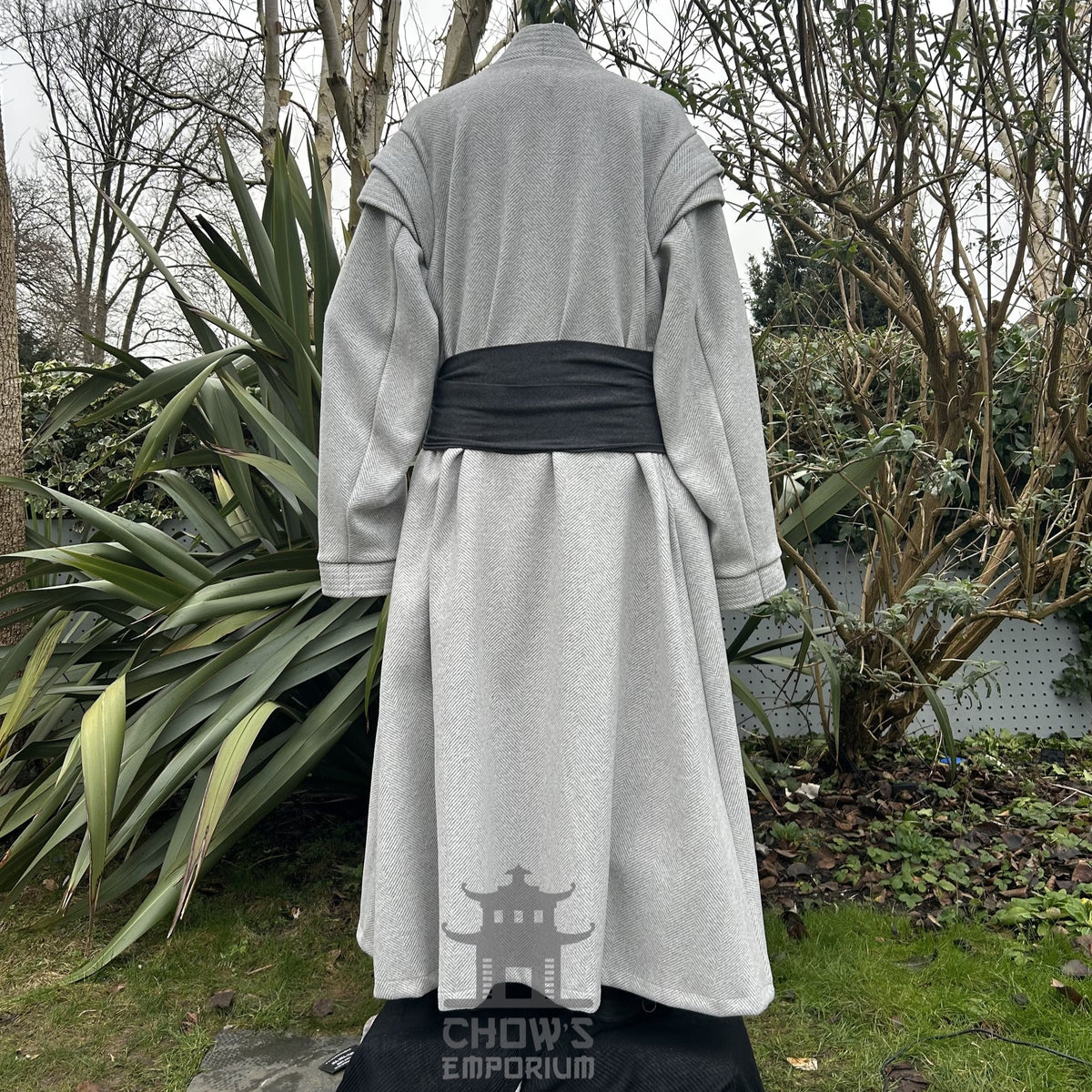 Medieval LARP costume back view, featuring a light grey full length robe, tunic, trousers, and sash.