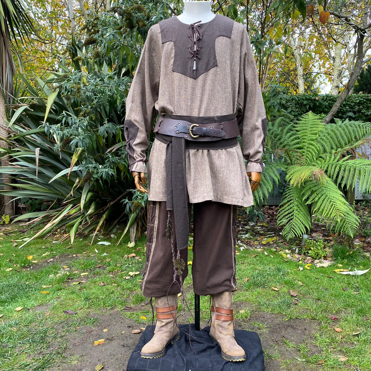 Medieval LARP outfit front view with detailed belt and woodland backdrop.