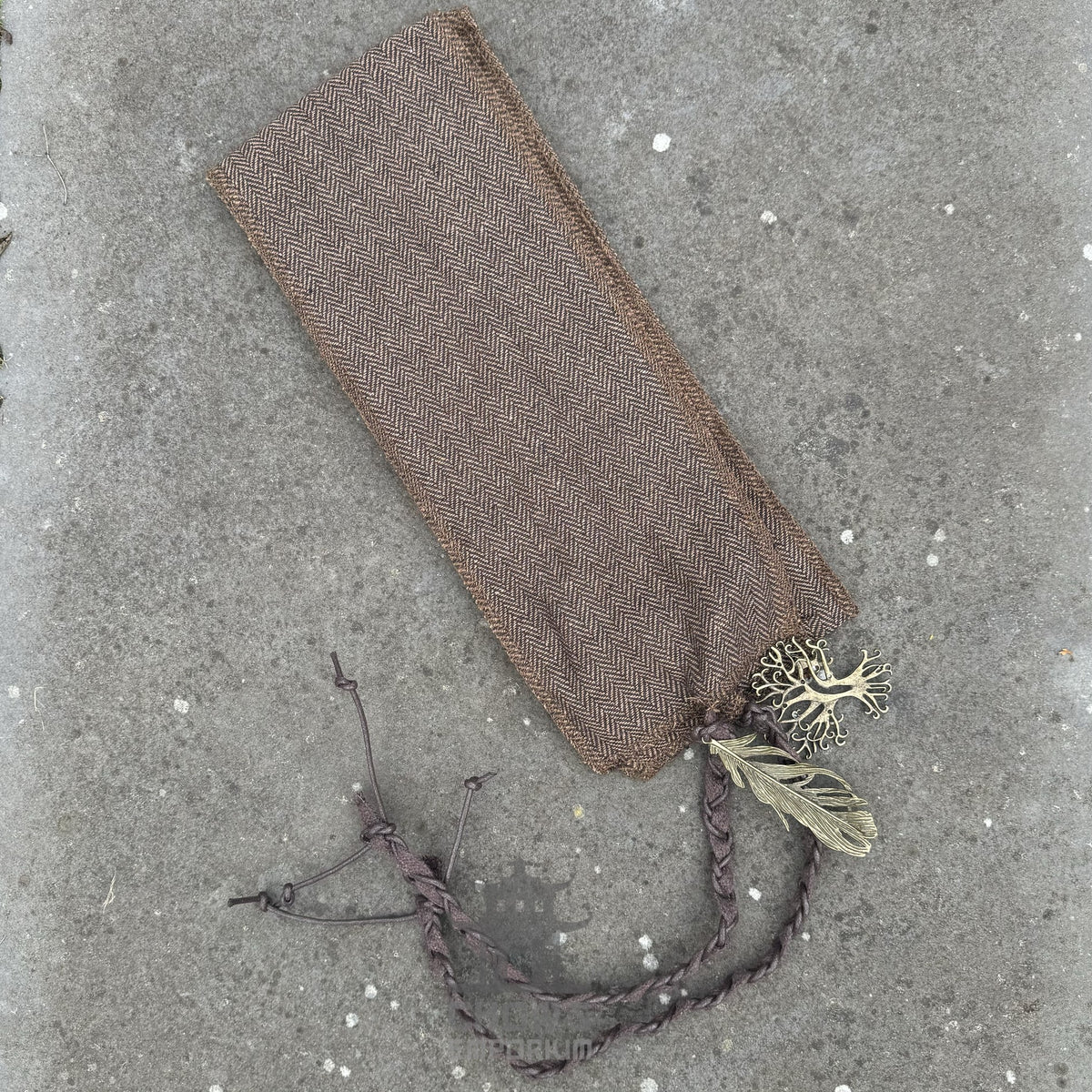 Brown medieval sash with woven texture, adorned with leaf and tree charms.