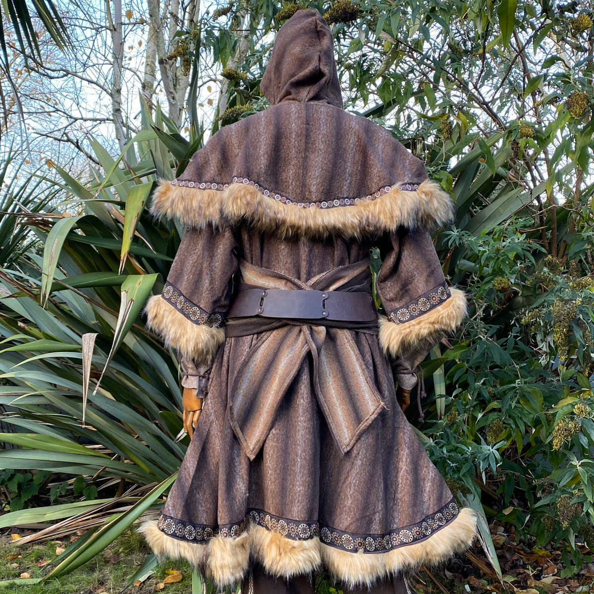 Back view of hooded medieval LARP outfit with fur trim and patterned edges.