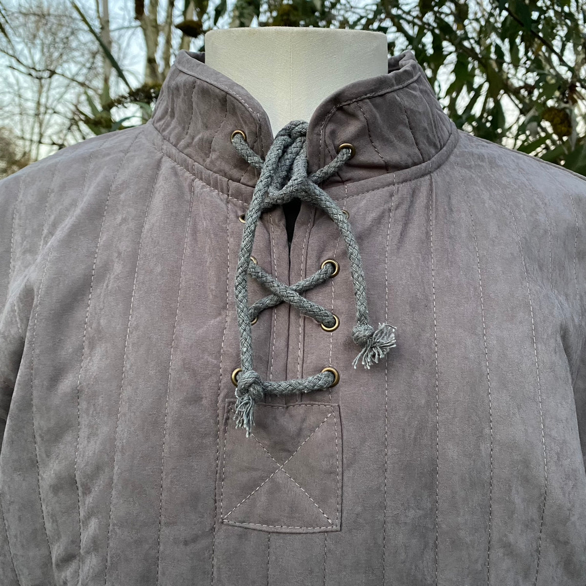 Grey gambeson close-up with lace-up detail for medieval LARP costume.