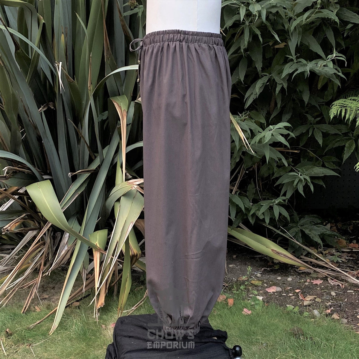 Side view of grey cotton LARP pants with reinforced stitching and cord tie waist.