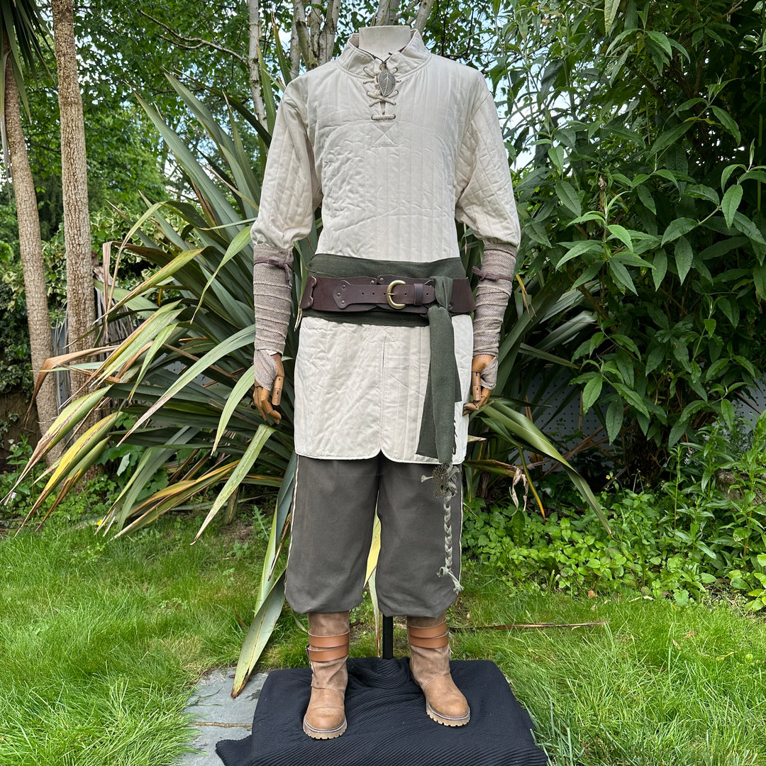 White cotton gambeson for LARP, front view, worn with medieval attire.