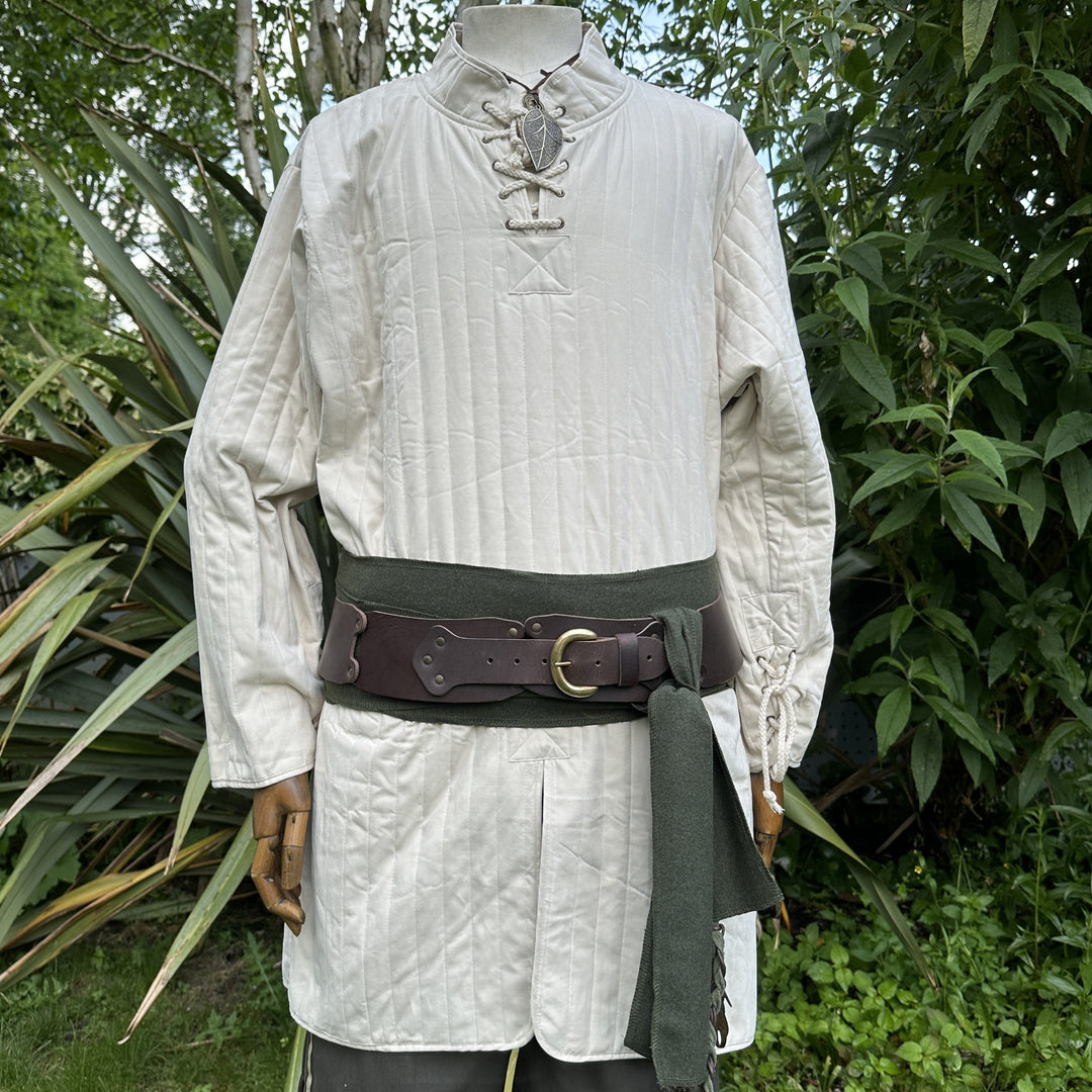 White quilted medieval gambeson with green sash, leather belt.
