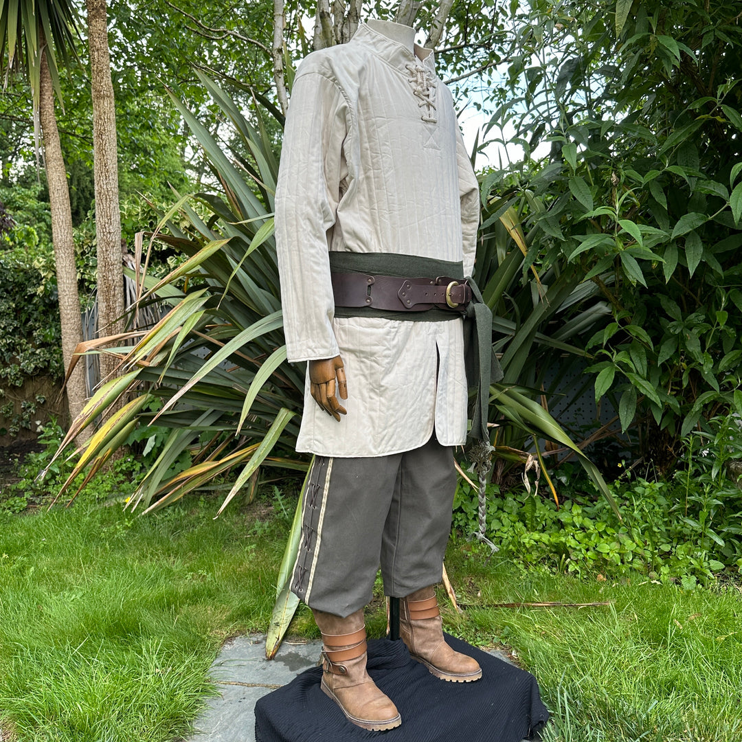 White quilted gambeson, dark pants, green sash, LARP medieval outfit display.