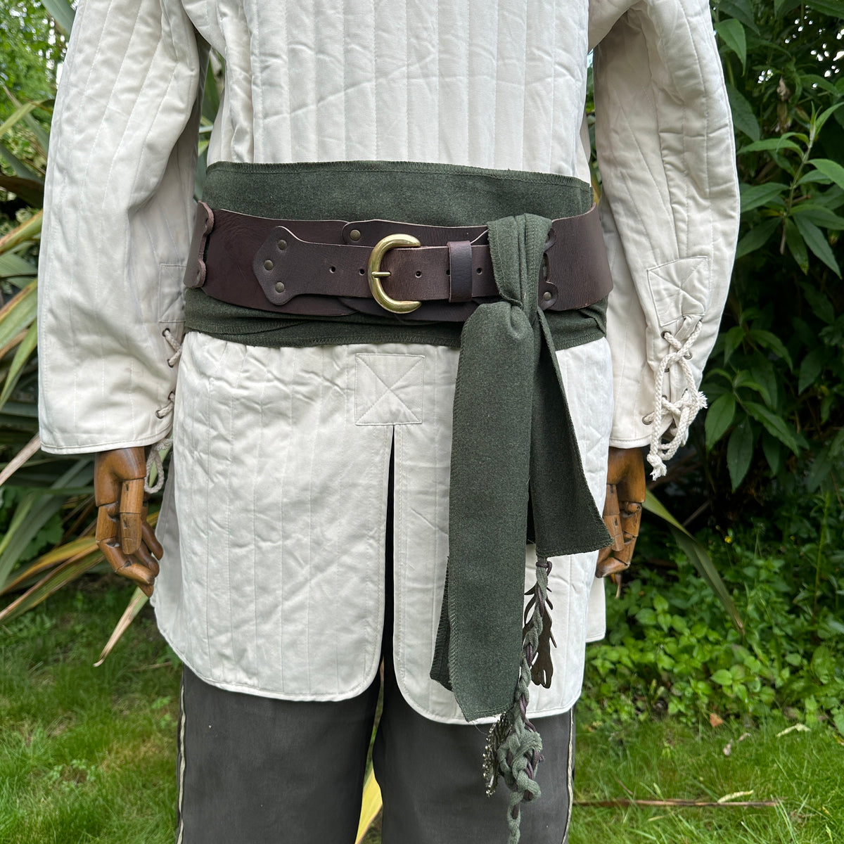 White cotton gambeson for LARP, medieval style, waist-close angle.