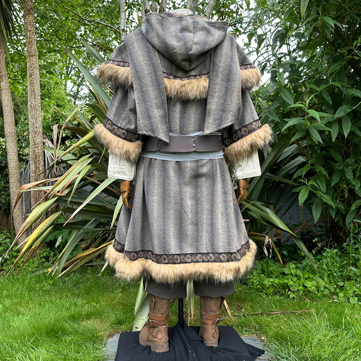 LARP medieval outfit with brown-grey tunic, hood, sash, fur trim, back view.